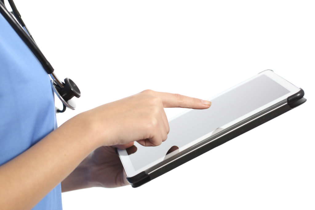 Side view of a nurse or doctor hand using a tablet isolated on a white background